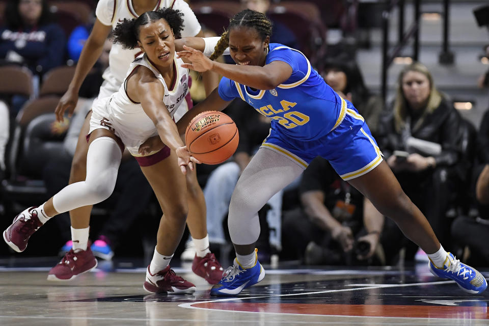 Florida State guard Sara Bejedi, left, reaches for the ball against UCLA guard Charisma Osborne, right, in the first half of an NCAA college basketball game, Sunday, Dec. 10, 2023, in Uncasville, Conn. (AP Photo/Jessica Hill)