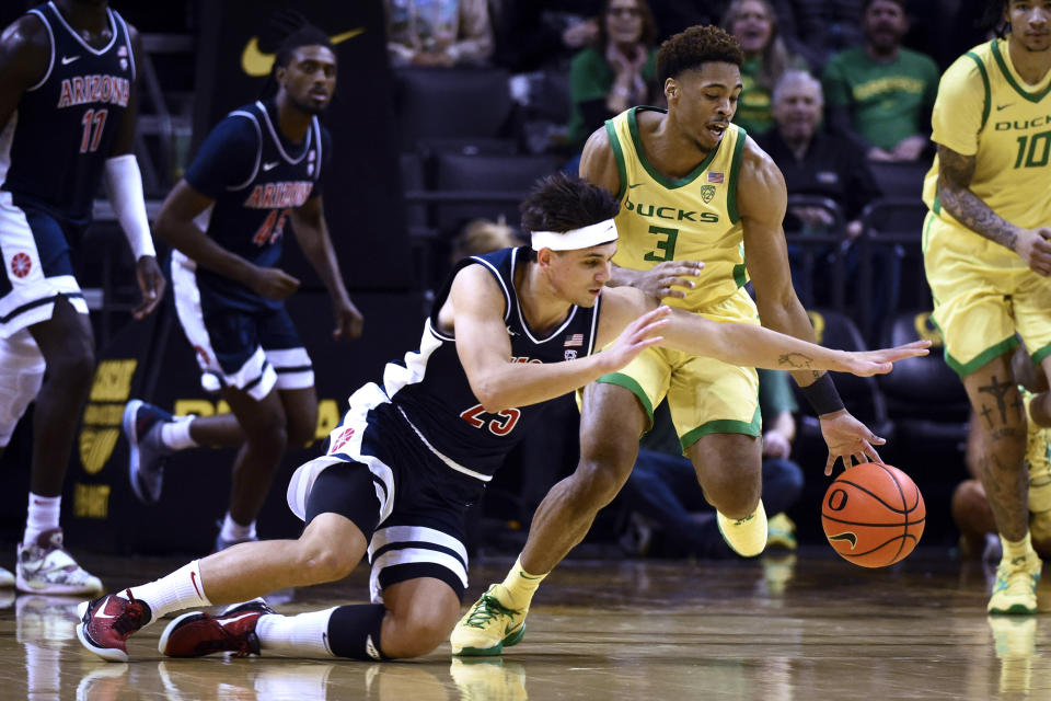 Arizona guard Kerr Kriisa (25) fouls Oregon guard Keeshawn Barthelemy (3) as he tries to steal the ball during the first half of an NCAA college basketball game Saturday, Jan. 14, 2023, in Eugene, Ore. (AP Photo/Andy Nelson)