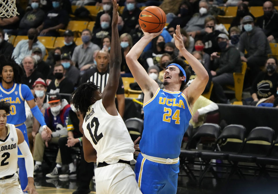 UCLA guard Jaime Jaquez Jr. shoots over Colorado forward Jabari Walker during the first half of an NCAA college basketball game Saturday, Jan. 22, 2022, in Boulder, Colo. (AP Photo/David Zalubowski)