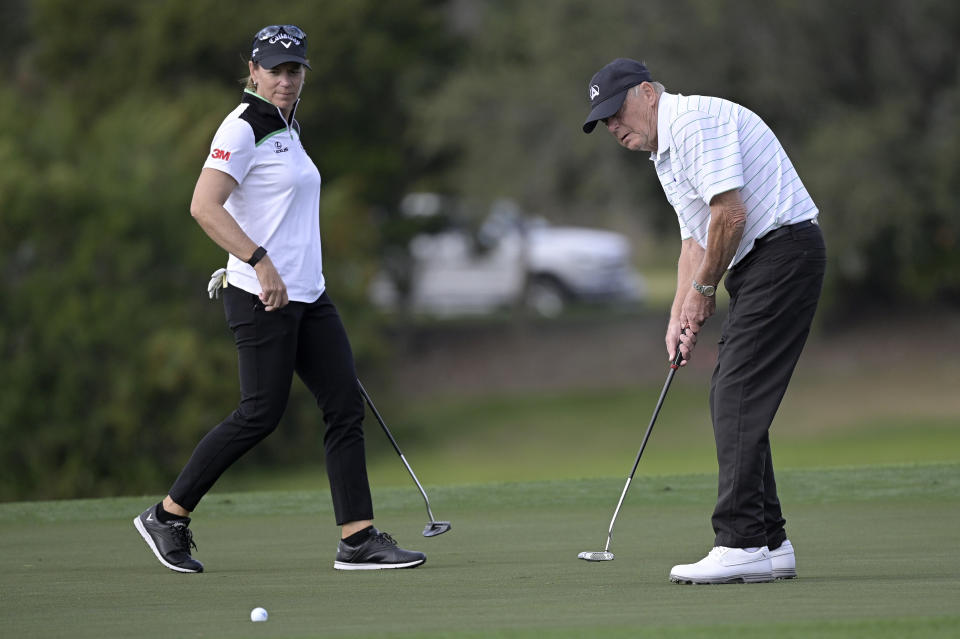 Annika Sorenstam, left, of Sweden, watches as her father Tom Sorenstam sinks his putt on the 14th green during the first round of the PNC Championship golf tournament, Saturday, Dec. 19, 2020, in Orlando, Fla. (AP Photo/Phelan M. Ebenhack)