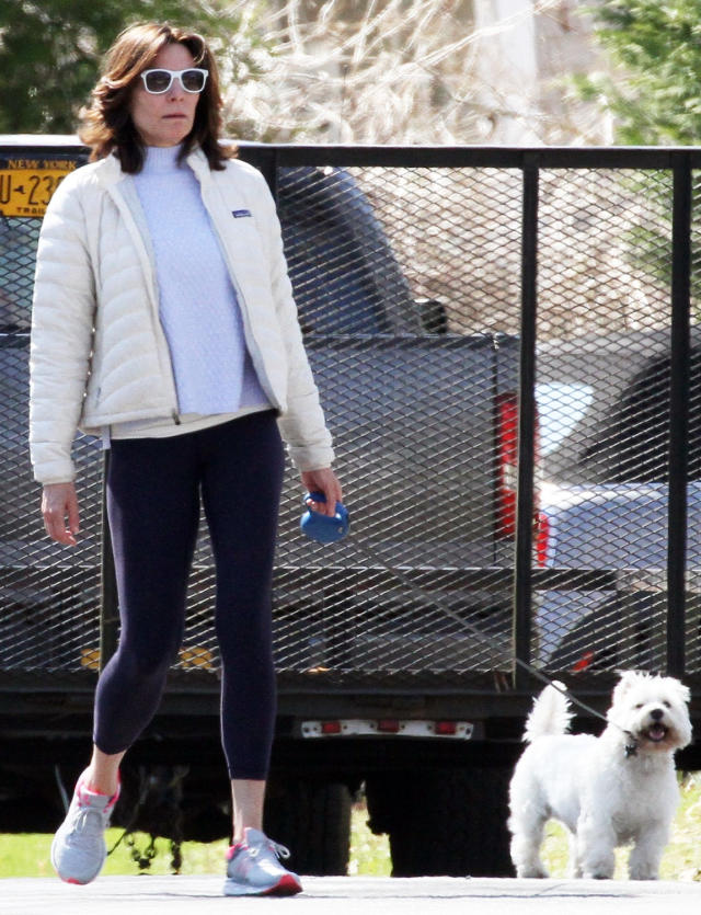 Abby Champion sports a white hoodie and black leggings during a power walk  in Brentwood, California