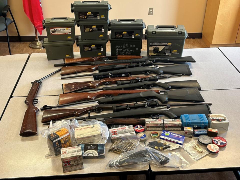 Police display weapons and ammunition seized from a home in New Glasgow, N.S., on Wednesday. All guns were licensed to their 66-year-old owner, but he has been charged with unsafe storage of firearms.  (Pictou County District RCMP - image credit)