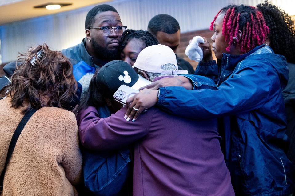 The family of fallen Deputy Jeryius Young hug each other as the Montgomery County Sheriff's Office holds a celebration of life, Thursday April 11, 2024 at the sheriff’s office in Montgomery, Ala., honoring Deputy Young, who died from injuries he sustained in a crash while responding to a call.