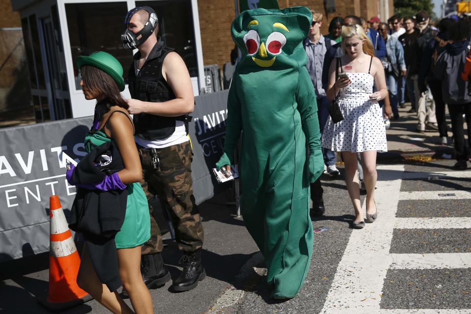 People dressed in costume enter New York's Comic-Con convention October 9, 2014. (REUTERS/Shannon Stapleton)