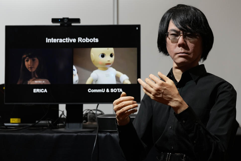 A robot that looks like Japanese professor Hiroshi Ishiguro interacts with visitors during the International Conference on Robotics and Automation ICRA in London, Tuesday, May 30, 2023. The 2023 ICRA brings together the world's top academics, researchers, and industry representatives to show the newest developments. Hiroshi Ishiguro is director of the Intelligent Robotics Laboratory, part of the Department of Systems Innovation in the Graduate School of Engineering Science at Osaka University. (AP Photo/Frank Augstein)