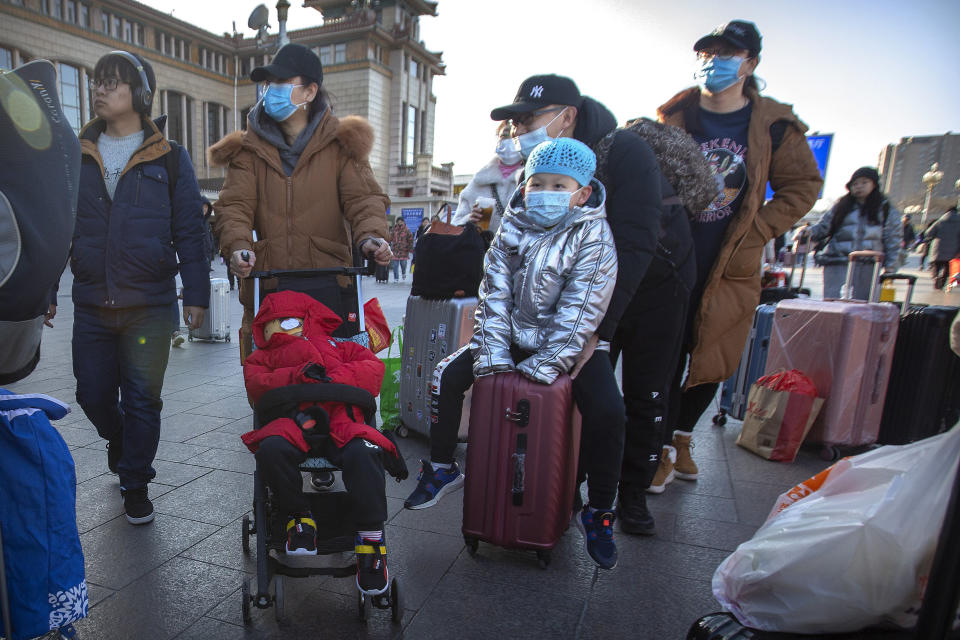 Travelers wear face masks outside of the Beijing Railway Station on Jan. 20, 2020. China reported a sharp rise in the number of people infected with a new coronavirus on Monday, including the first cases in the capital. The outbreak coincides with the country's busiest travel period as millions board trains and planes for the Lunar New Year holidays.&nbsp; (Photo: ASSOCIATED PRESS)