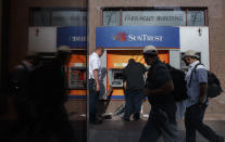 Workers repair a damaged SunTrust cash machine in Washington, Monday, June 1, 2020, after a night protests over the death of George Floyd. Floyd died after being restrained by Minneapolis police officers on May 25. (AP Photo/Carolyn Kaster)