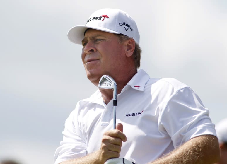 Hal Sutton watches his tee shot on the 12th hole during the final round of the 3M Championship.