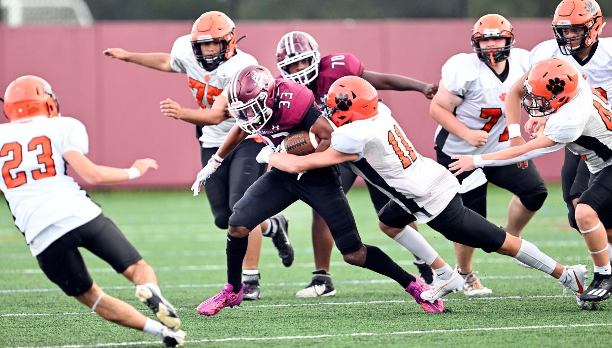 Tre'Chaun Days of Falmouth drags Tyler Moore of Marlborough.