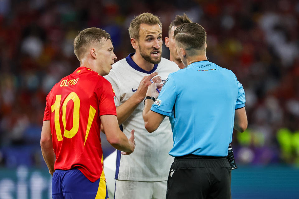 14 July 2024, Berlin: Soccer: European Championship, Spain - England, final round, final, Olympiastadion Berlin. Spain's Dani Olmo (l) and England's Harry Kane discuss with referee Francois Letexier from France. Photo: Christian Charisius/dpa (Photo by A4281 Christian Charisius/picture alliance via Getty Images)