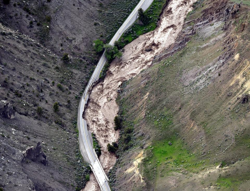 The highway between Gardiner and Mammoth in Montana is washed out trapping tourists in Gardiner, as historic flooding damages roads and bridges and floods homes along area rivers on Monday, June 13, 2022 (AP)