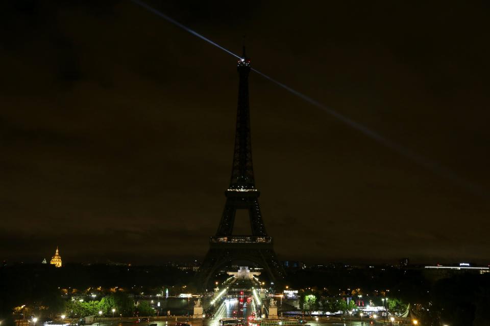 The lights of the Eiffel Tower in Paris are switched off in solidarity.