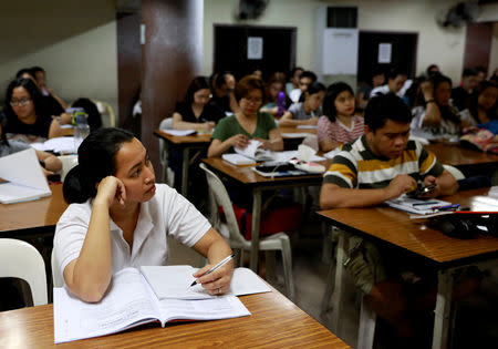 Filipino workers, including nurses applying to work in United Kingdom, attend a lecture at a review center for the International English Language Testing System or IELTS in Manila, Philippines, April 2, 2019. Picture taken April 2, 2019. REUTERS/Eloisa Lopez