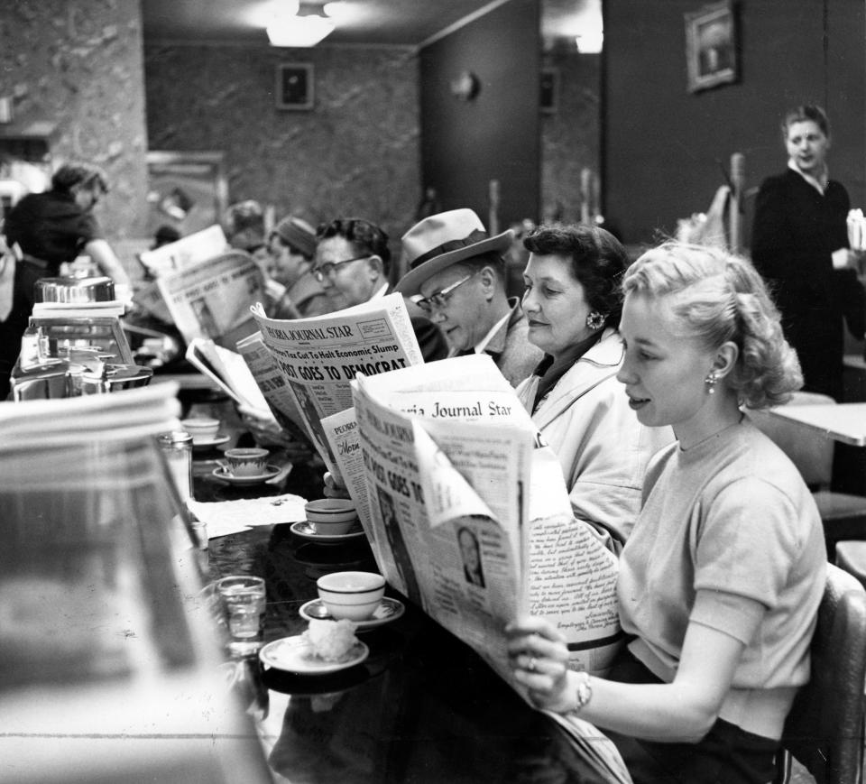 In this photo from March 11, 1958, diners enjoy the Peoria Journal Star at a local restaurant.