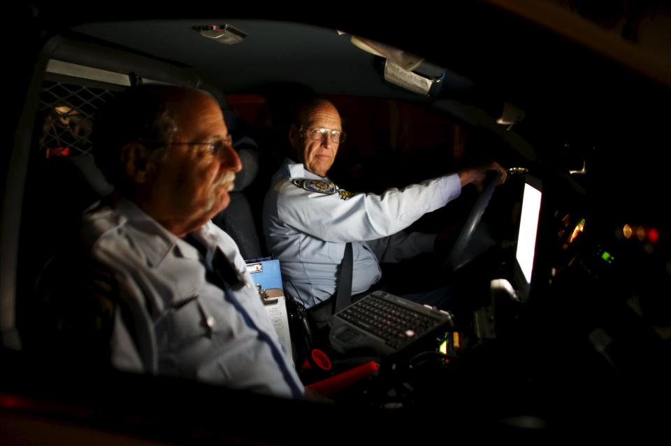 Retired Senior Volunteer Patrol member Henry Miller drives on patrol with partner Steve Rubin (L) as they search for a vehicle involved in a hit and run accident in San Diego, California, United States March 10, 2015. (REUTERS/Mike Blake)