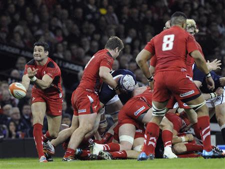 Wales' Mike Phillips (L) releases the ball against Scotland during their Six Nations Championship rugby union match at the Millennium Stadium, Cardiff, Wales, March 15, 2014. REUTERS/Rebecca Naden