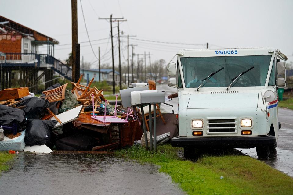 Montegut Postmaster Derrick Campbell delivers mail amid destruction from Hurricane Ida in Pointe-aux-Chenes on Sept. 14, 2021.