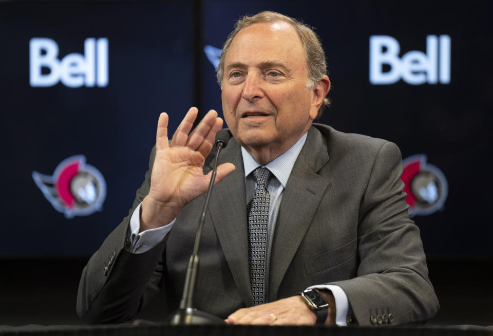 NHL Commissioner Gary Bettman waves as he begins a news conference before an Ottawa Senators NHL hockey game against the Florida Panthers, Monday, March 27, 2023, in Ottawa, Ontario. (Adrian Wyld/The Canadian Press via AP)