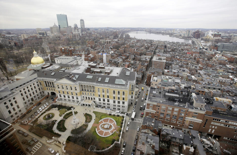 FILE- In this Jan. 31, 2017, file photo a portion of the Boston Skyline is seen through a window in Boston. For more than a year, cities around the country, including Boston, waited in suspense over whether they'd be chosen as Amazon's second home. On Tuesday, Nov. 13, Amazon announced that it had picked for its new East Coast headquarters the New York neighborhood of Long Island City, Queens as well as a suburb of Washington, in Arlington, Va. (AP Photo/Steven Senne, File)