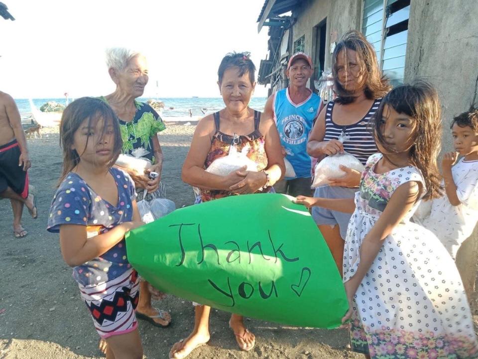 Residents in the Philippines receive rice donations as part of Harold Mortel's fundraising initiatives.