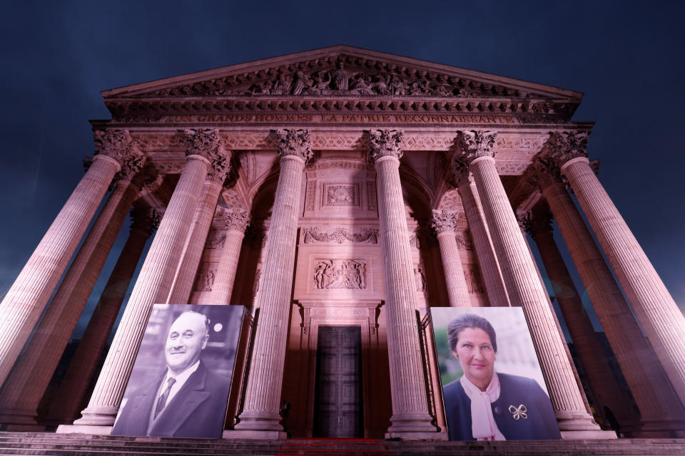 Giant portraits of late French politician Simone Veil, right, and diplomat Jean Monne, left, are displayed outside the Pantheon before a tribute ceremony at the French Pantheon in Paris, Friday, Jan. 7, 2022. French president Emmanuel Macron paid a tribute to a pair of leading European figures Friday as France formally took the reins of the 27-nation bloc for the next six months with big ambitions. (Ludovic Marin, Pool Photo via AP)