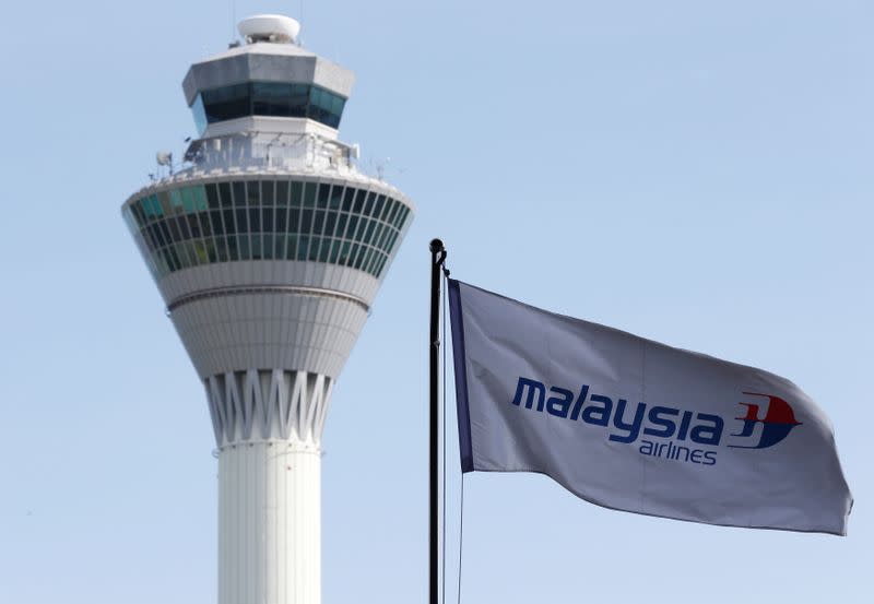 Malaysian Airlines flag flies in front of the traffic control tower at Kuala Lumpur International Airport in Sepang