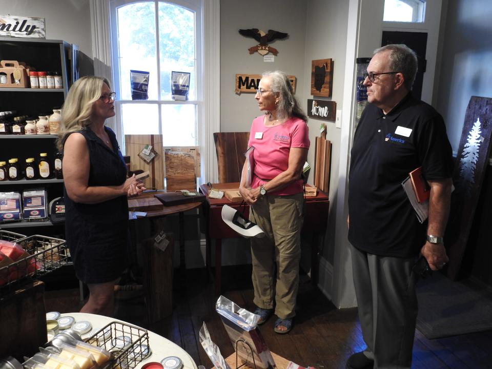 Mindy Brems of the Coshocton Visitors Bureau in Roscoe Village meets with America in Bloom advisers Kirk Brown and Cheryl Corson during their visit this past summer. Coshocton always scores high marks in the national floral and landscape contest for its history preservation and volunteerism, among other categories.