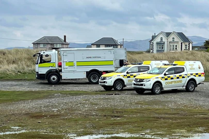 Coastguards and the Army’s Emergency Ordnance Disposal unit at the beach