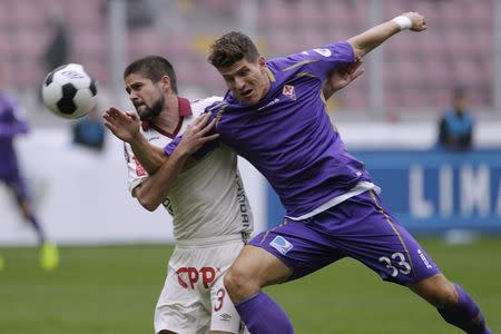 Mario Gomez (R) of Italy's Fiorentina fights for the ball with Werner Schuler of Peru's Universitario during their Copa Euroamericana soccer match in Lima, August 2, 2014. REUTERS/Enrique Castro-Mendivil