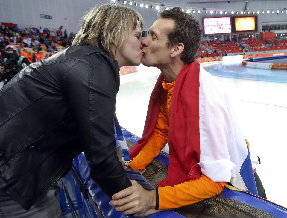 Stefan Groothuis of the Netherlands kisses his wife Ester after winning the gold in the men's 1,000-meter speedskating race at the Adler Arena Skating Center at the 2014 Winter Olympics in Sochi, Russia, Wednesday, Feb. 12, 2014.(AP Photo/Pavel Golovkin)