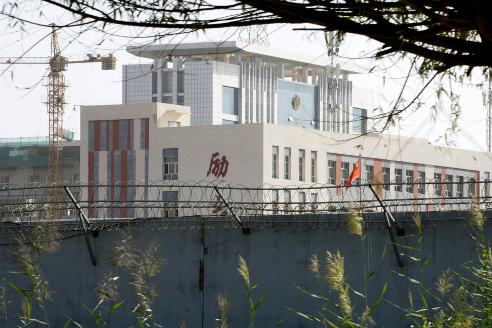 In this Aug. 31, 2018, photo, barbed wire protects the walls around a cluster of schools on the outskirts of Kashgar, in western China's Xinjiang region. Uighurs fear the Chinese government's expansion of compulsory Mandarin-intensive classes and boarding schools away from home will gradually erode their children's Central Asian ethnic identity and Islamic beliefs. (AP Photo/Ng Han Guan)