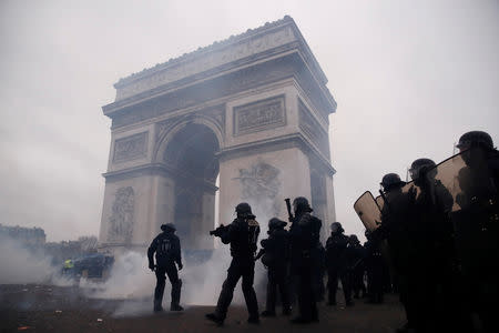 Riot policemen stand guard during a demonstration by the "yellow vests" movement near the Arc de Triomphe in Paris, France, January 12, 2019. REUTERS/Christian Hartmann