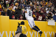 Seattle Seahawks tight end Gerald Everett (81) leaping into the stands after scoring a touchdown against the Washington Football Team during the first half of an NFL football game, Monday, Nov. 29, 2021, in Landover, Md. (AP Photo/Julio Cortez)