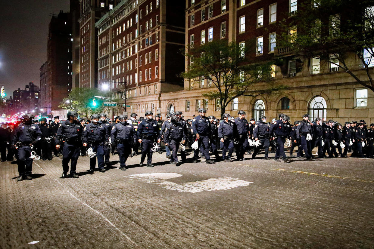 NYPD officers in riot gear march onto Columbia University. (Kena Betancur / AFP - Getty Images)