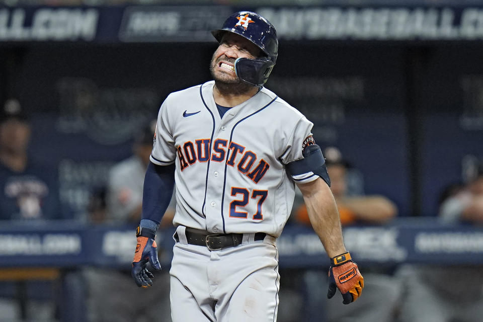 Houston Astros' Jose Altuve grimaces in pain after getting hit by a pitch from Tampa Bay Rays starting pitcher Corey Kluber during the fifth inning of a baseball game Wednesday, Sept. 21, 2022, in St. Petersburg, Fla. Altuve remained in the game. (AP Photo/Chris O'Meara)