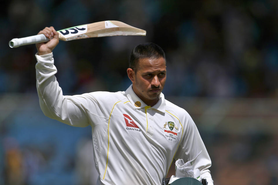 Australia's Usman Khawaja raises his bat to acknowledge crowd as he walks back to pavilion after his dismissal on 160 runs during 2nd day of second test match between Pakistan and Australia at the National Stadium, in Karachi, Pakistan, Sunday, March 13, 2022. (AP Photo/Anjum Naveed)