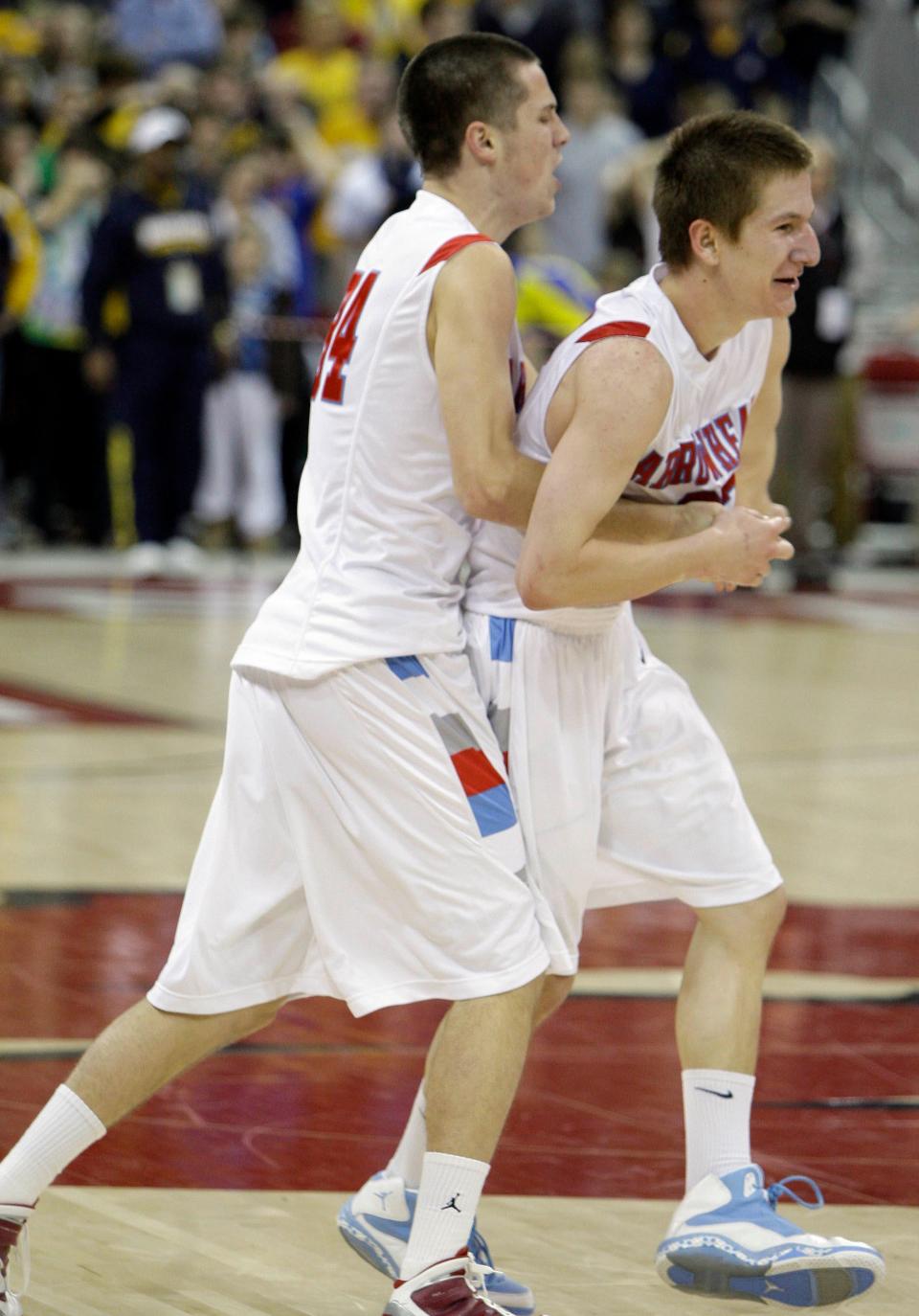 Arrowhead's Charles Rushman is embraced by teammate Ryan May after making the game-winning shot during the second half of their semifinal game Friday, March 19, 2010, during the WIAA state tournament at the Kohl Center in Madison.