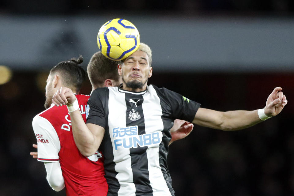 Newcastle's Jonjo Shelvey, left, jumps for a header with Arsenal's Dani Ceballos, during the English Premier League soccer match between Arsenal and Newcastle at the Emirates Stadium in London, Sunday, Feb. 16, 2020.(AP Photo/Frank Augstein)