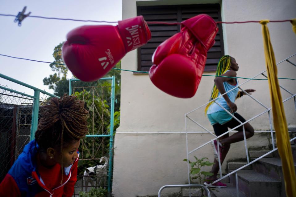 In this Jan. 19, 2017 photo, boxer Legnis Cala runs up a flight of stairs in the backyard of her house, in Havana, Cuba. "I see myself at the Olympics in Japan 2020," Moreno said. "That's my dream." Pictured at bottom left is boxer Idamelys Moreno. (AP Photo/Ramon Espinosa)