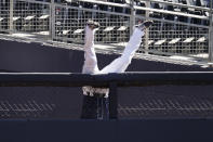 Tampa Bay Rays right fielder Manuel Margot tumbles over a right field wall after catching a foul ball by Houston Astros center fielder George Springer during the second inning in Game 2 of a baseball American League Championship Series, Monday, Oct. 12, 2020, in San Diego. (AP Photo/Jae C. Hong)