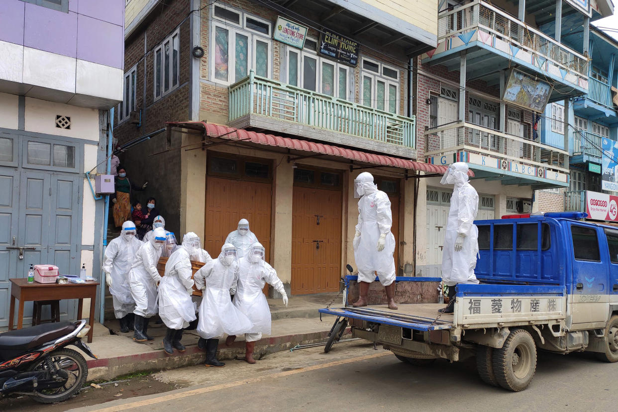 This handout photo from local media group Tedim Post taken and released on June 29, 2021, shows health workers carrying a coffin bearing the remains of a Covid-19 coronavirus victim who died at home in Tedim, western Chin state.