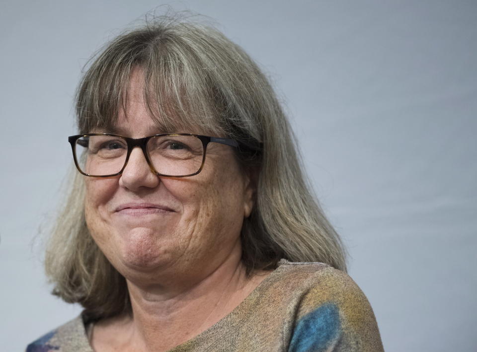 Noble Prize winner Donna Strickland smiles as she receives a standing ovation before speaking to the media during a news conference regarding her prestigious award in Waterloo, Ontario, Tuesday, Oct. 2, 2018. Strickland, of the University of Waterloo in Canada, became only the third woman to win the physics Nobel, and the first in 55 years. (Nathan Denette/The Canadian Press via AP)