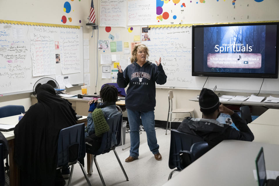 World literature teacher Ann Marie Willoughby speaks with students at Penn Wood High School in Lansdowne, Pa., Wednesday, May 3, 2023. As schools across the country struggle to find teachers to hire, more governors are pushing for pay increases and bonuses for the beleaguered profession. (AP Photo/Matt Rourke)