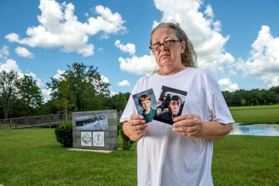 Sarah Burch holds photos of her son, Chadrick Wade, at Semmes Municipal Park one recent Sunday in Semmes, Alabama. Wade died in the Fountain Correctional Facility on July 4, 2022.