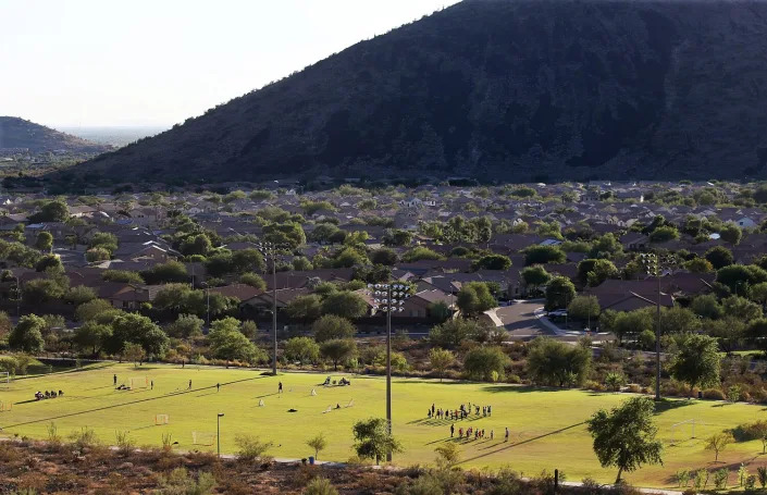 Overhead shot of a green outdoor athletic field surrounded by suburbs