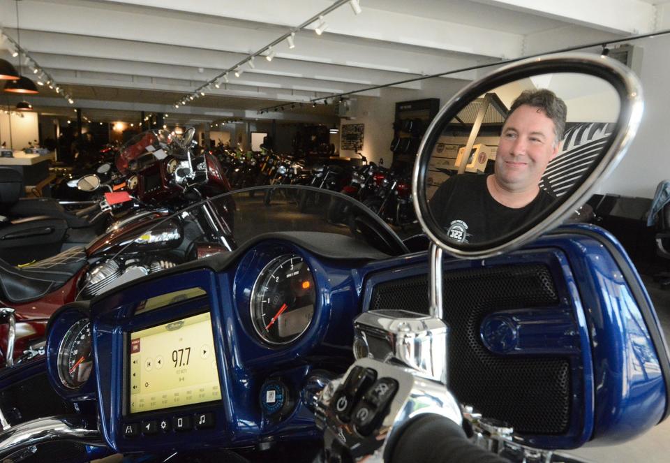 Eric Krasun, co-owner with his sister Monica Karsun-Mish, with a motorcycle at their new Street Stuff Cycle showroom in Norwich.