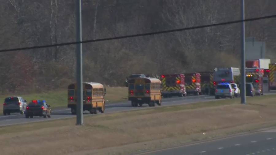 Two school buses escorted by police approach at accident scene on Interstate 70 near Etna, Ohio, on Nov. 14, 2023 (NBC4)