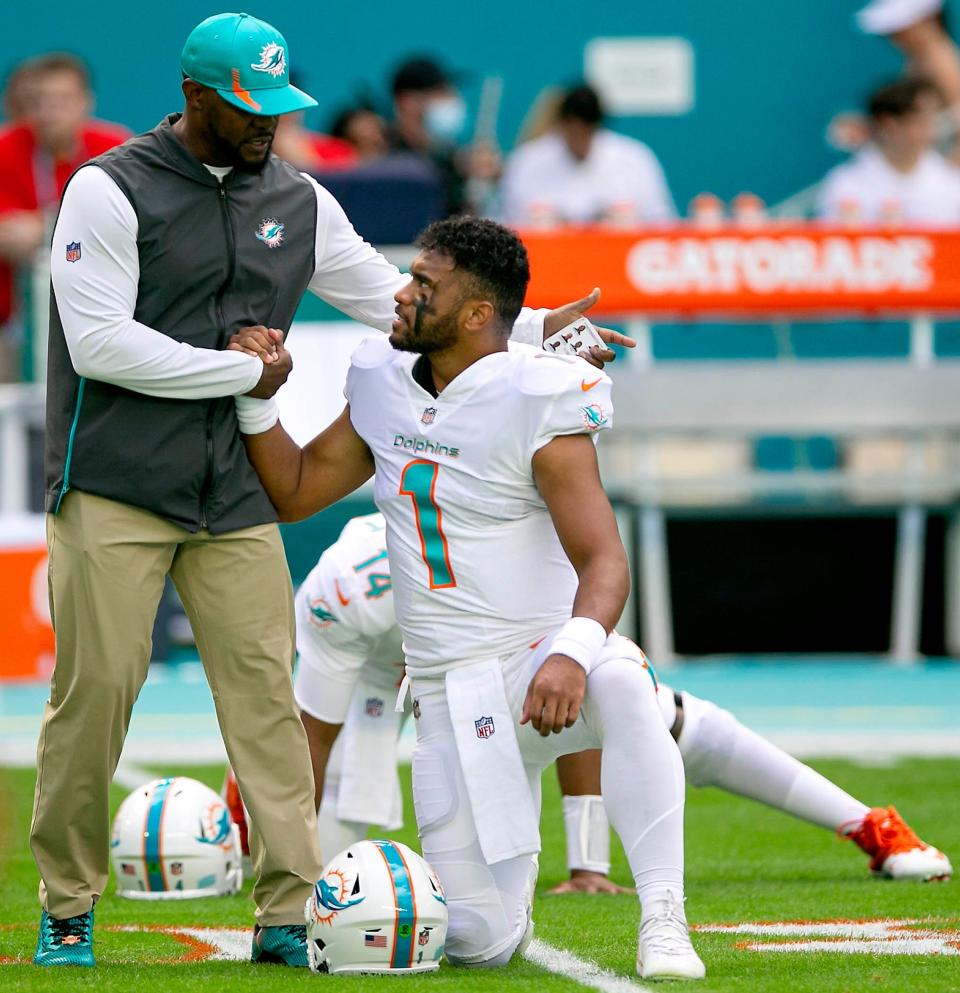 Then-Dolphins head coach Brian Flores shakes hands with quarterback Tua Tagovailoa before the start of their game against the New York Giants  last December at Hard Rock Stadium.