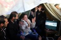 Relatives of Lebanese soldiers and policemen kidnapped by a jihadist group from the eastern border town of Arsal last year watch news reports about the release of their loved ones in downtown Beirut on December 1, 2015