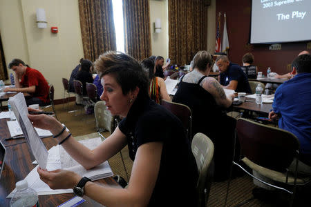 High school english teacher Kate Gubata reads a part during a training session by the group History Unerased (HUE), which aims to provide educators with materials about the role lesbian, gay bisexual and transgender people have played in the history of the United States, in Lowell, Massachusetts, U.S., May 18, 2017. REUTERS/Brian Snyder